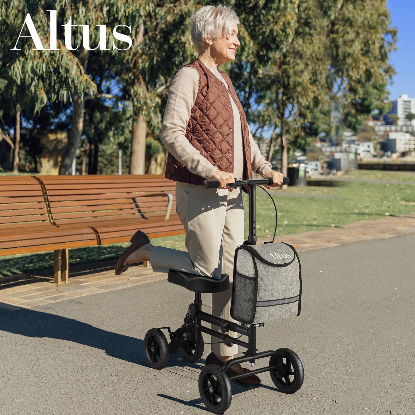 Woman using a knee scooter in a park with 'Altus' branding.