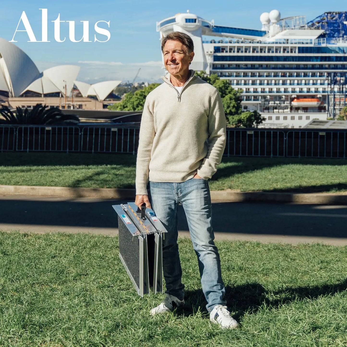A senior man showcasing the Altus Aluminum Threshold Portable Wheelchair Ramp with a scenic background of iconic landmarks. The ramp’s portable design ensures it can be easily carried and set up for providing reliable access and independence.