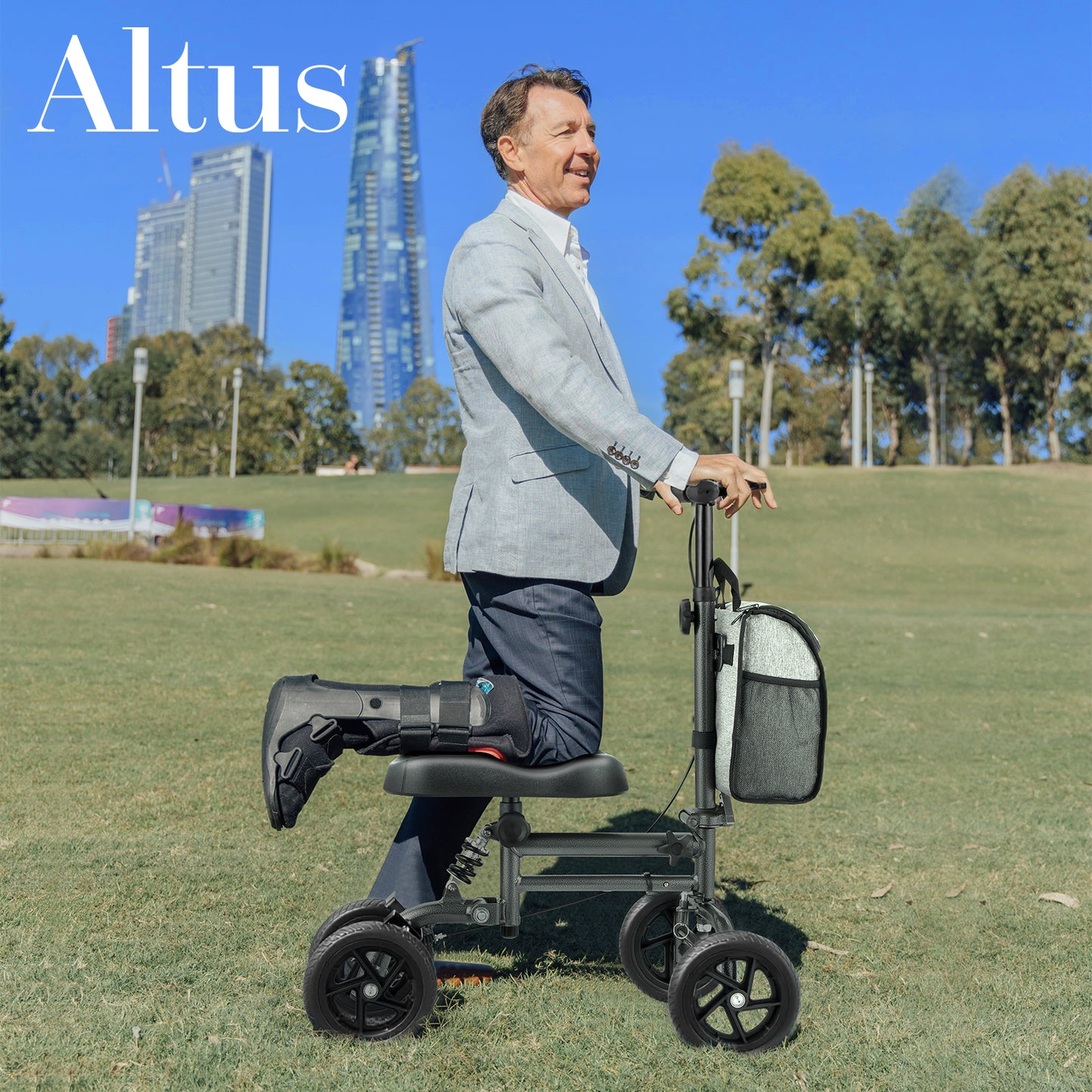 Altus Knee Walker Scooter with 8-inch wheels, ideal for outdoor use and leg injury recovery, shown by a man in a park