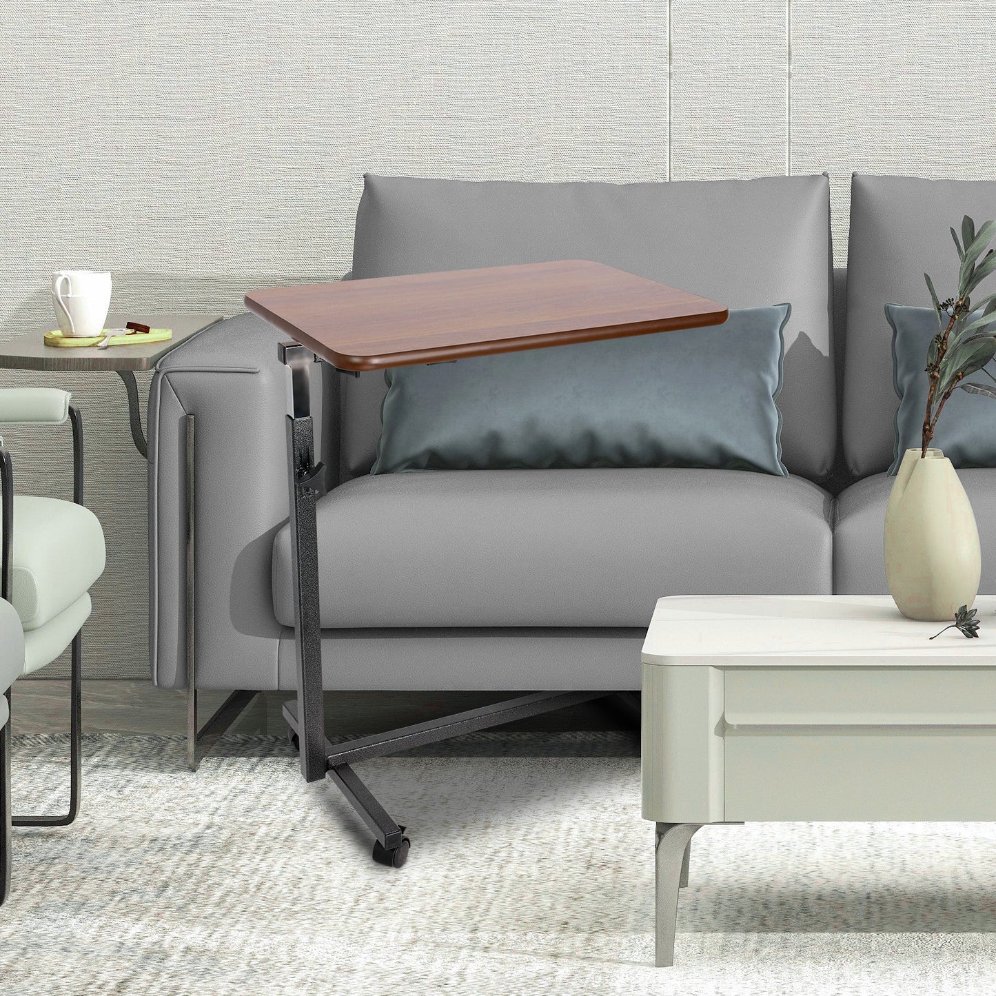 Altus overbed table placed beside a sofa, highlighting its compact design for comfortable use in living spaces.