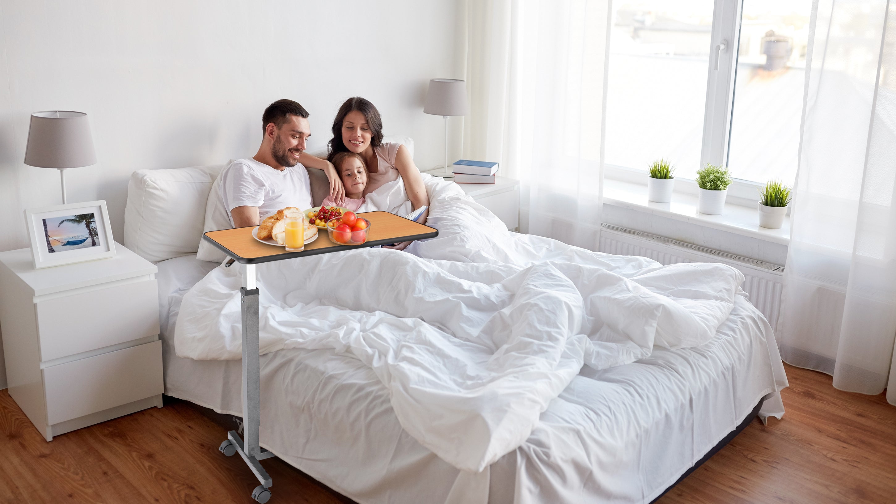 As shown, the family relaxes comfortably in bed while the overbed table holds a delicious breakfast, creating a cosy shared moment. With adjustable height, smooth mobility, and a sturdy, minimalist design, it blends into any home and enhances daily living comfort.