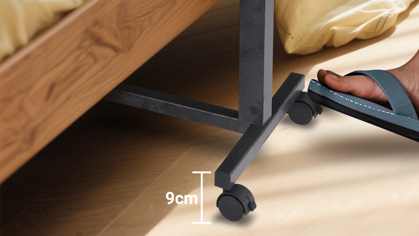 This overbed table features smooth-rolling castor wheels with easy foot-operated locks for secure placement. As shown, users can lock or unlock the wheels with a gentle tap, making it simple to position the table beside a bed or chair for stable and convenient use.