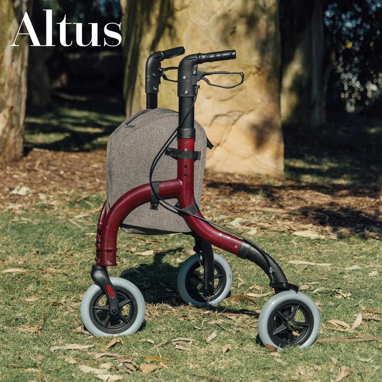 This image shows the Altus Euro Style Rollator in a park setting. The rollator, in a sleek red color, is positioned on the grass, highlighting its stability and suitability for outdoor use. The large wheels and sturdy frame ensure smooth mobility on various terrains, making it ideal for active seniors who enjoy outdoor activities. The image also showcases the rollator's modern design and practical features, such as the comfortable handles and storage bag.
