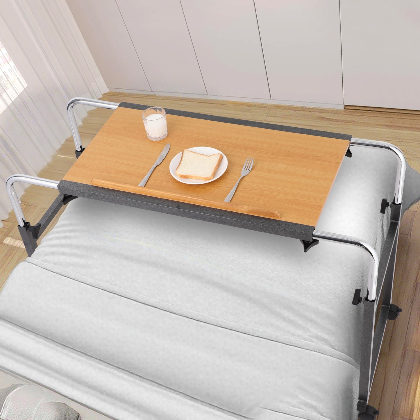 As an Adjustable Overbed Table, it rests securely across the bedside, perfect for holding meals, drinks, and other items. As shown, it provides a convenient dining solution for those confined to bed, enabling comfort without getting up.