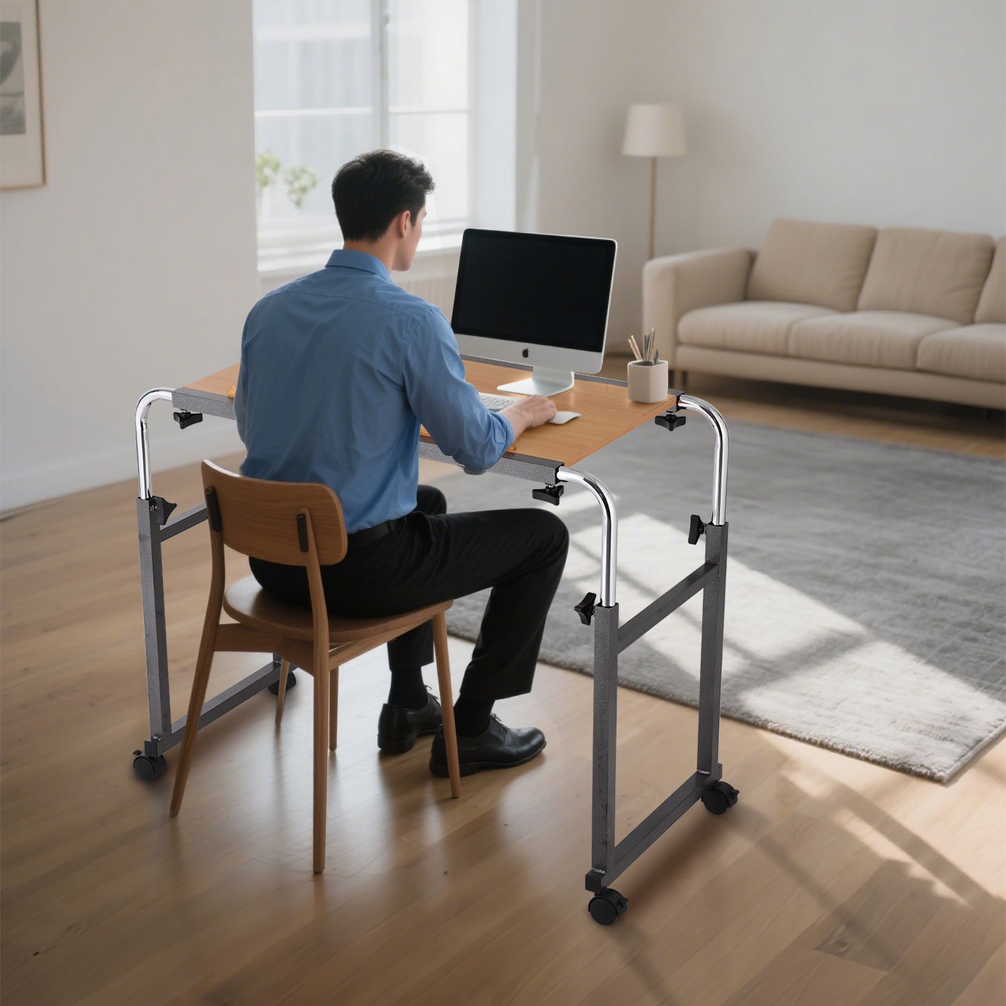 As seen in the image, the Adjustable Overbed Table serves as a home office desk with a wide surface suitable for laptops and supplies. Its adjustable height supports ergonomic posture and efficient work.