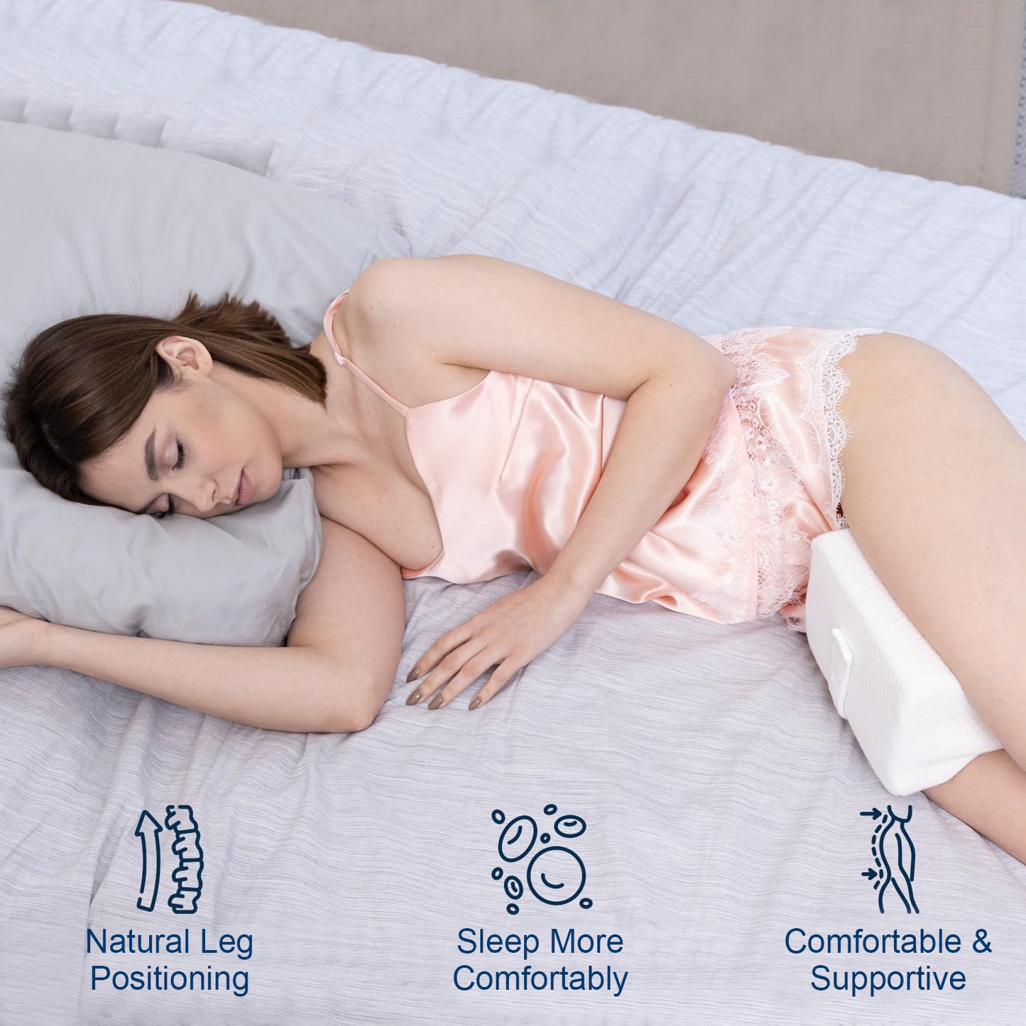 Woman sleeping on a bed with a pillow, promoting natural leg positioning, comfort, and support.