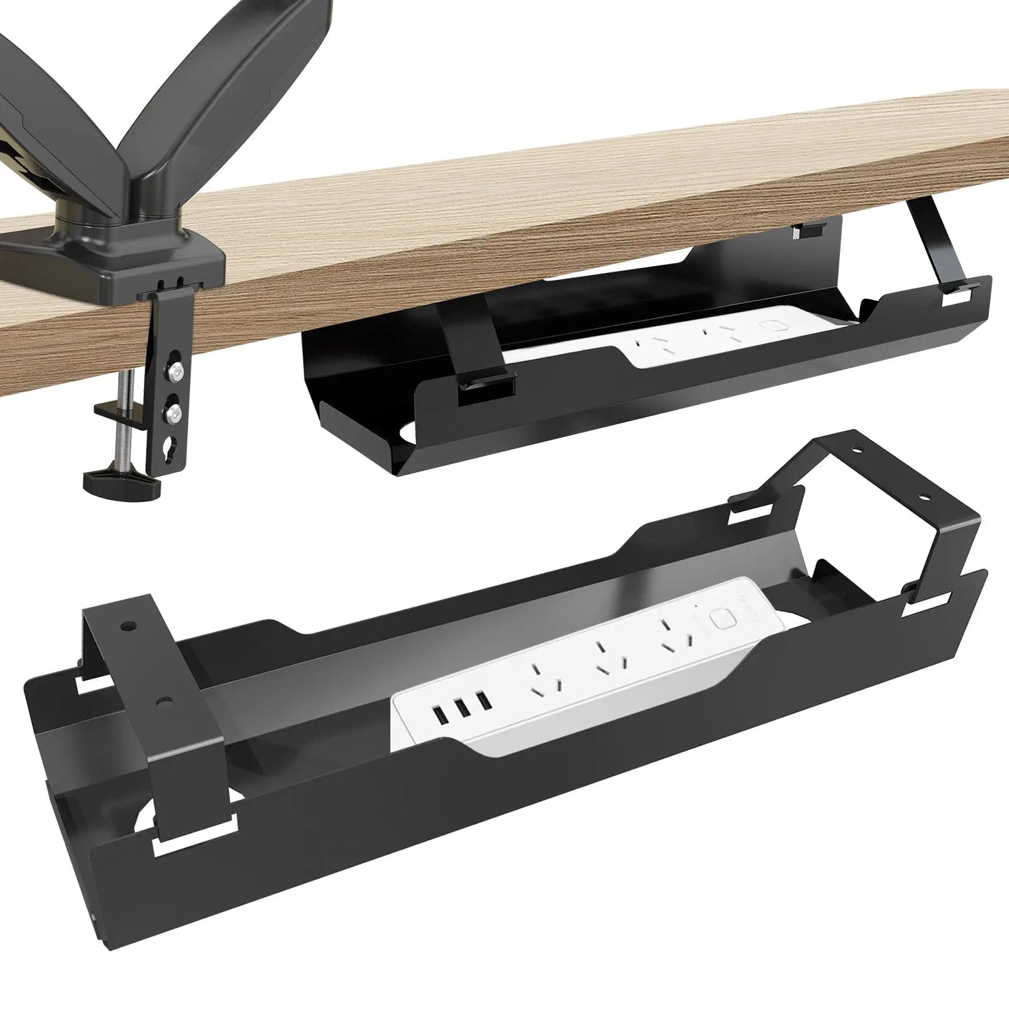 Black metal cable management tray clamped under a wooden desk, holding a power strip with multiple outlets and USB ports." This setup keeps cables organized and out of sight, maintaining a tidy workspace.