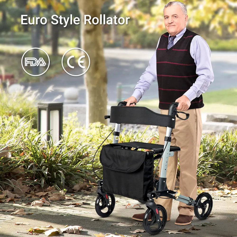Elderly man using a Euro-style rollator with ergonomic handles and storage bag, in a park.
