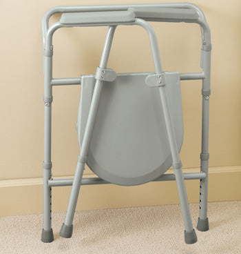 Gray commode chair with metal frame on a beige carpeted floor.