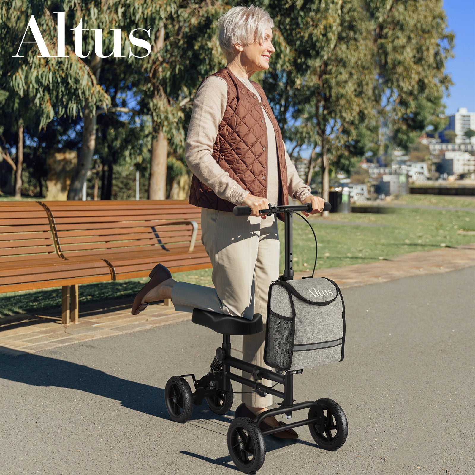 Woman using a knee scooter in a park with 'Altus' branding.