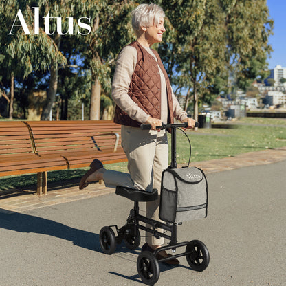 Woman using a knee scooter in a park with 'Altus' branding.