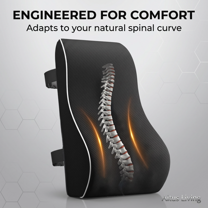A black contoured lumbar support pillow with a white edge trim, featuring a 3D graphic of a human spine and glowing orange compression zones on the front. The image includes the text 'ENGINEERED FOR COMFORT' and 'Adapts to your natural spinal curve' at the top, and the brand name 'Altus Living' in the bottom right corner.