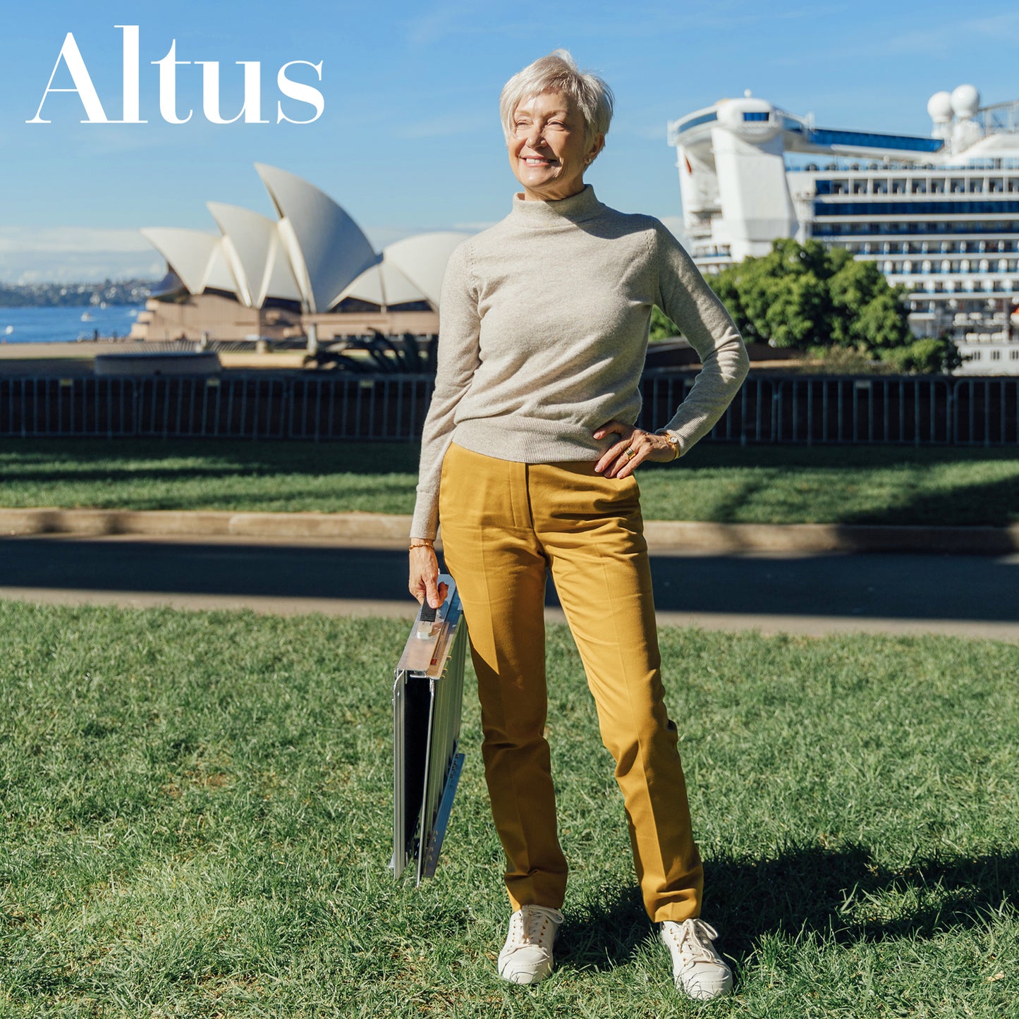 A senior woman confidently holding the Altus Aluminum Threshold Portable Wheelchair Ramp against a scenic backdrop. This lightweight, durable ramp is perfect for providing accessibility and ease of mobility over thresholds, steps, and curbs.