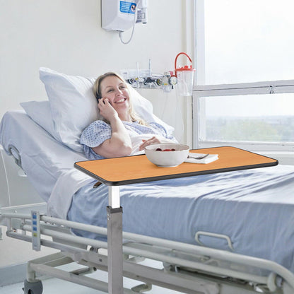 Overbed table in use by a patient in a hospital bed, providing a convenient surface for meals and activities.