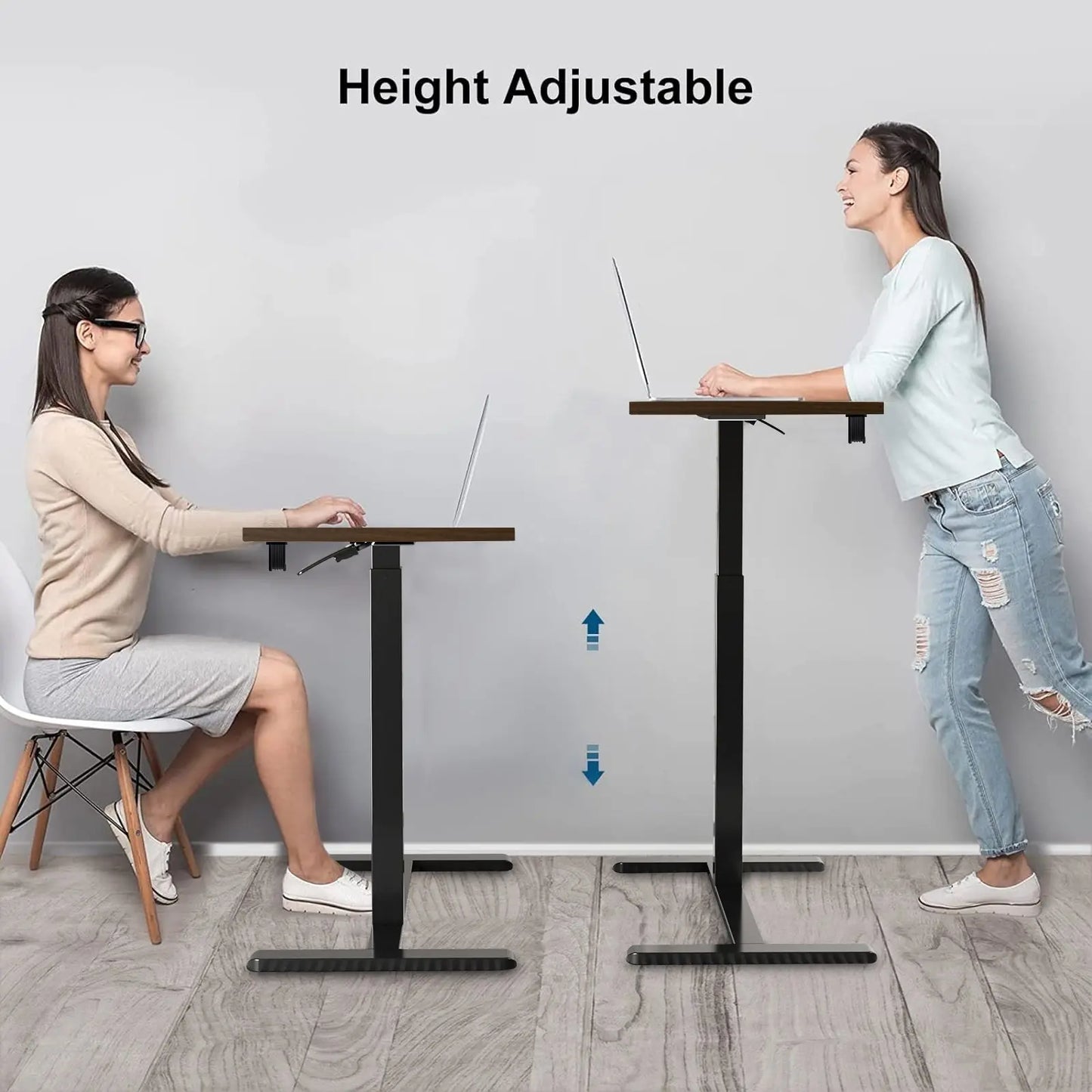 Two women demonstrating the height adjustability of a mobile standing desk, one seated and the other standing.