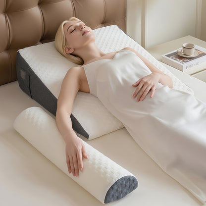 Woman lying on a bed with a wedge-shaped pillow