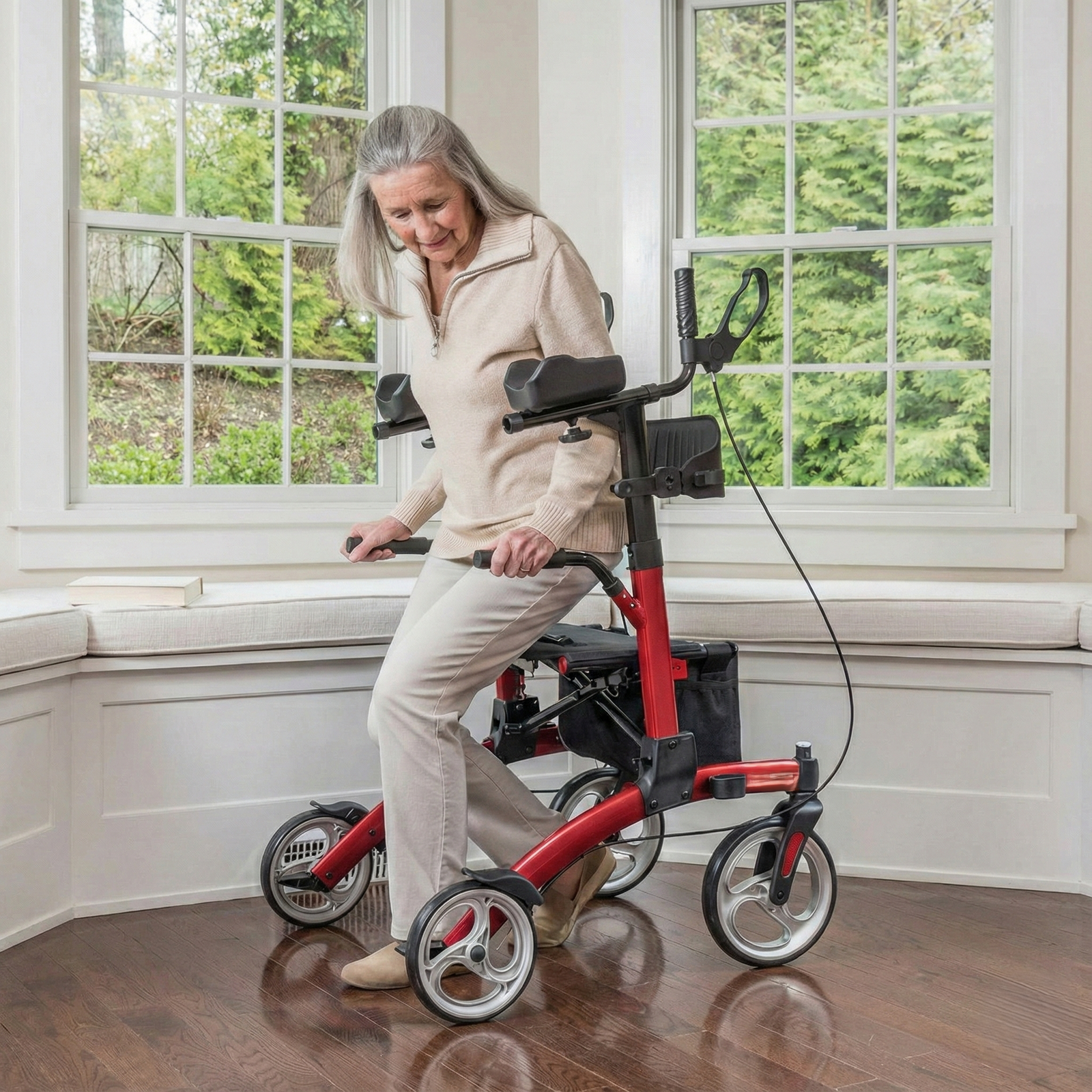 Woman using a red and black mobility scooter indoors with large windows in the background.