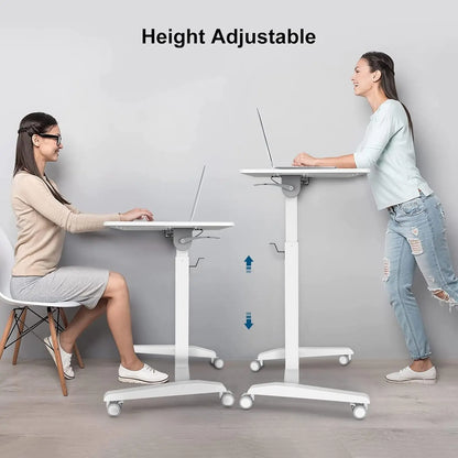 Two women in casual and business attire demonstrate the height adjustability of a mobile white desk for sitting or standing use.