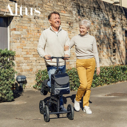 Another outdoor image of a man using the knee walker, this time dressed in a formal outfit. This showcases the knee walker’s versatility and suitability for various environments and occasions, supporting mobility for professionals as well.