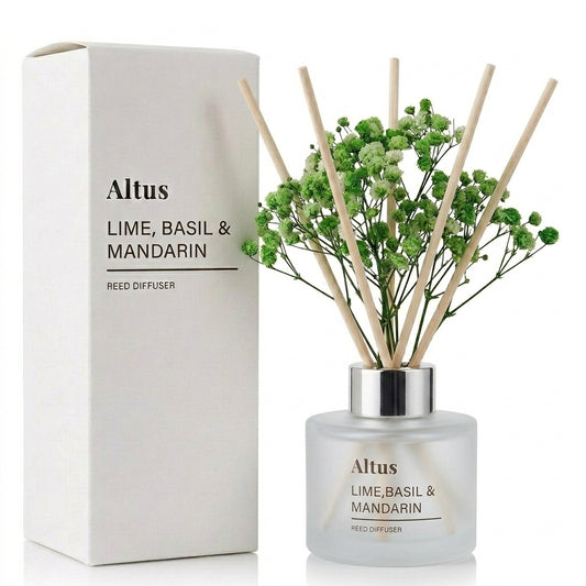 Altus Lime, Basil & Mandarin reed diffuser with a frosted glass bottle, natural bamboo reeds, and baby's breath flowers, shown next to its white cardboard packaging box on a white background.
