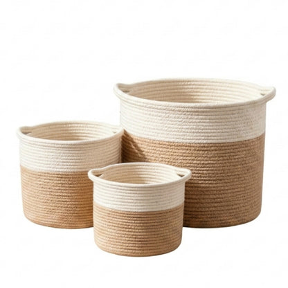 Three rope storage baskets in nested sizes with a two-tone design of cream and natural jute, on a white background.