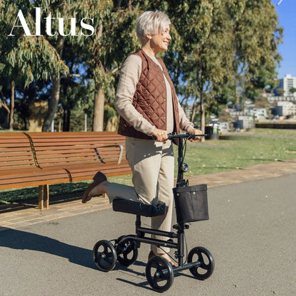 A senior woman enjoying her mobility with the Altus 8-Inch Wheel Knee Walker Scooter with Cover. This scooter features a comfortable knee platform, ergonomic handlebars, and a sturdy frame, providing excellent support and maneuverability for individuals recovering from foot or ankle injuries."