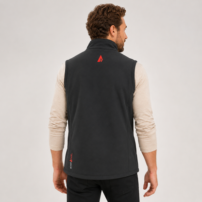 Man wearing a black vest with a red logo on the back against a light gray background