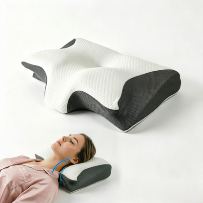 A contoured ergonomic pillow shown in two views: one floating above a person lying down wearing a pink shirt, and another showing the underside. The pillow features a white quilted top section and dark gray textured side panels.
