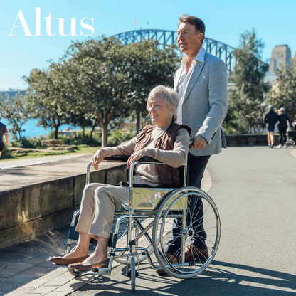 A senior woman enjoying a scenic view while sitting comfortably in the Altus Wheelchair with 24-Inch Wheels. This wheelchair features a durable and lightweight frame, providing excellent mobility and support for users, making it ideal for outdoor activities