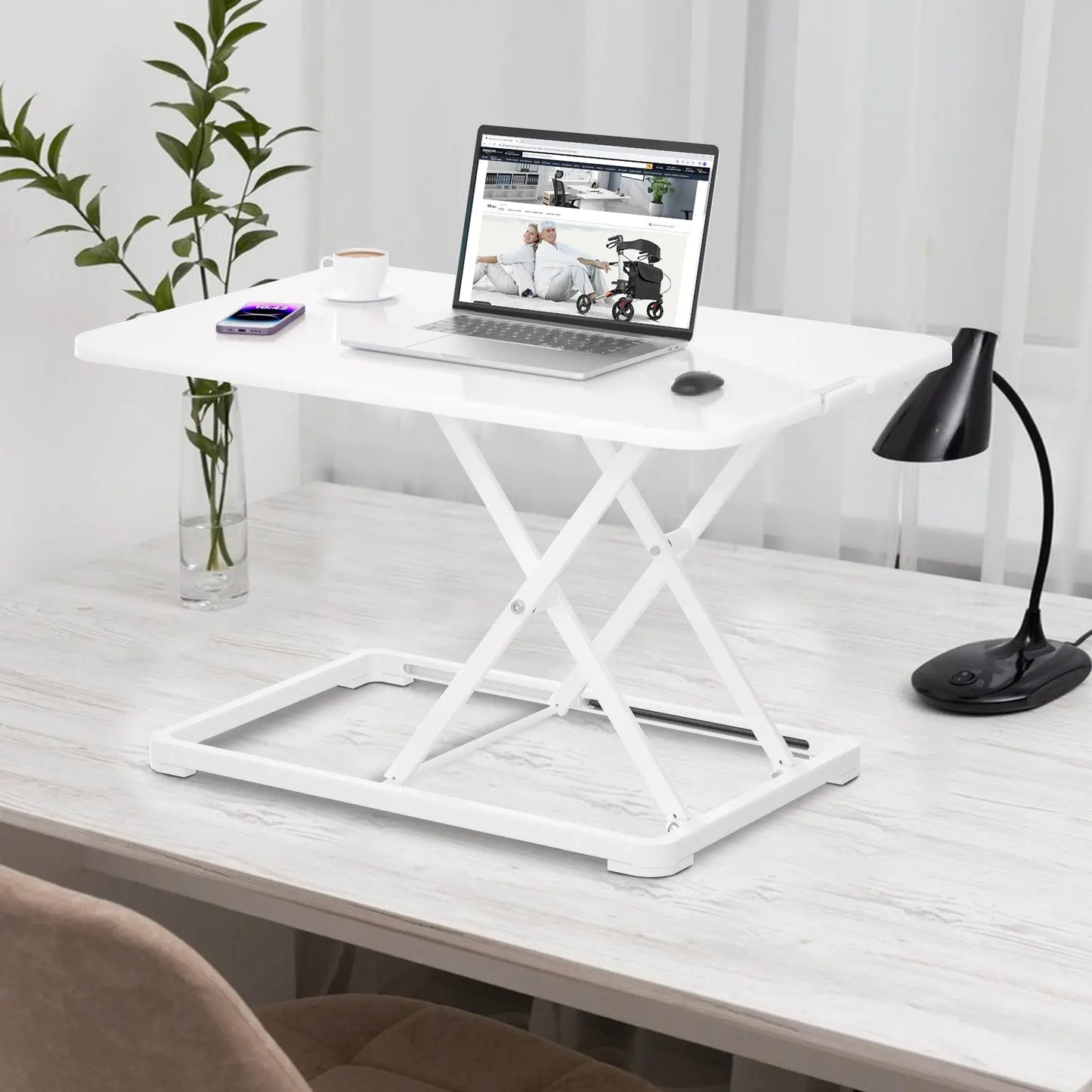 A sleek white standing desk positioned in a modern home office environment, accessorized with a laptop, smartphone, and stylish desk lamp.