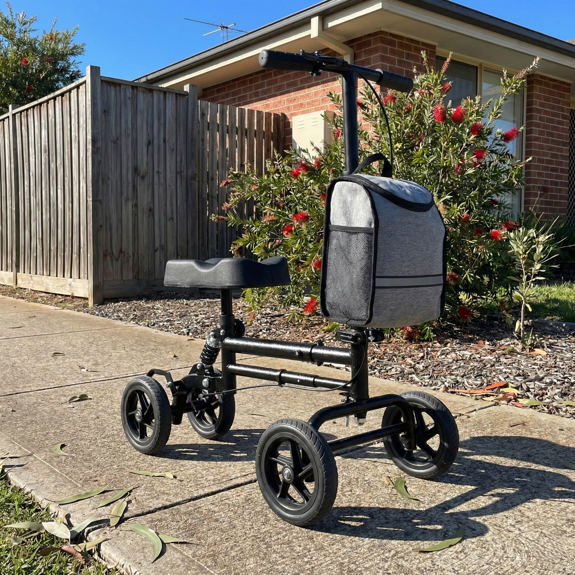 Knee walker with a backpack on a driveway in front of a house