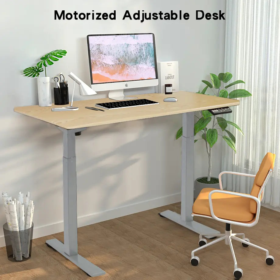 A realistic office setup with a motorized adjustable desk featuring a wooden top, placed near a window with curtains, supporting two computers and various desk accessories.