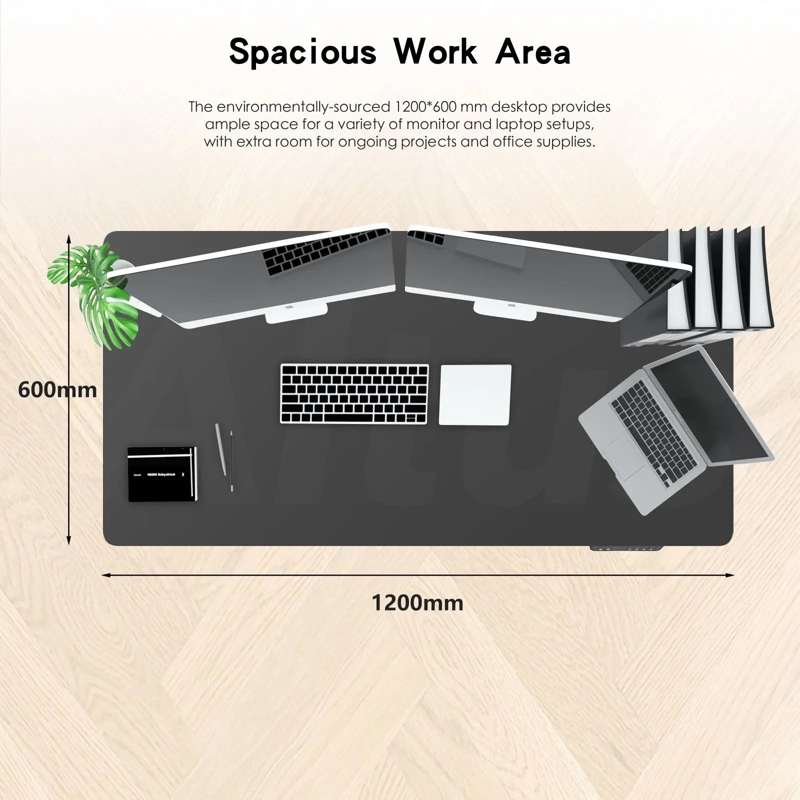 Overhead view of a 1200x600 mm black desk with laptops, keyboard, mouse, and office supplies, highlighting ample workspace.