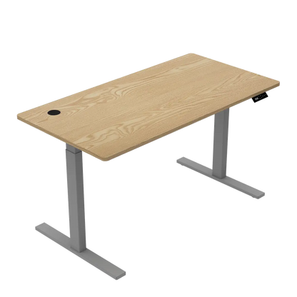 An isolated view of a motorized adjustable desk showcasing the wooden tabletop with a hole for cable management and a sturdy metal frame.