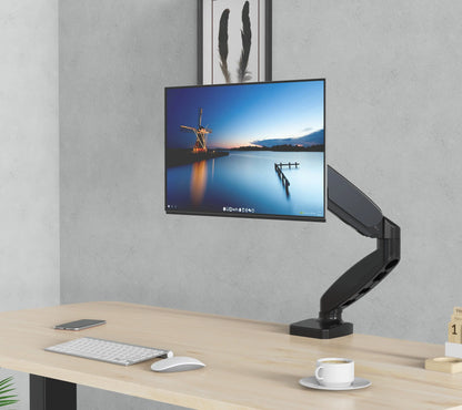 Ergonomic monitor arm set up in a modern home office, illustrating a clean and organized desk environment that promotes productivity and reduces clutter.